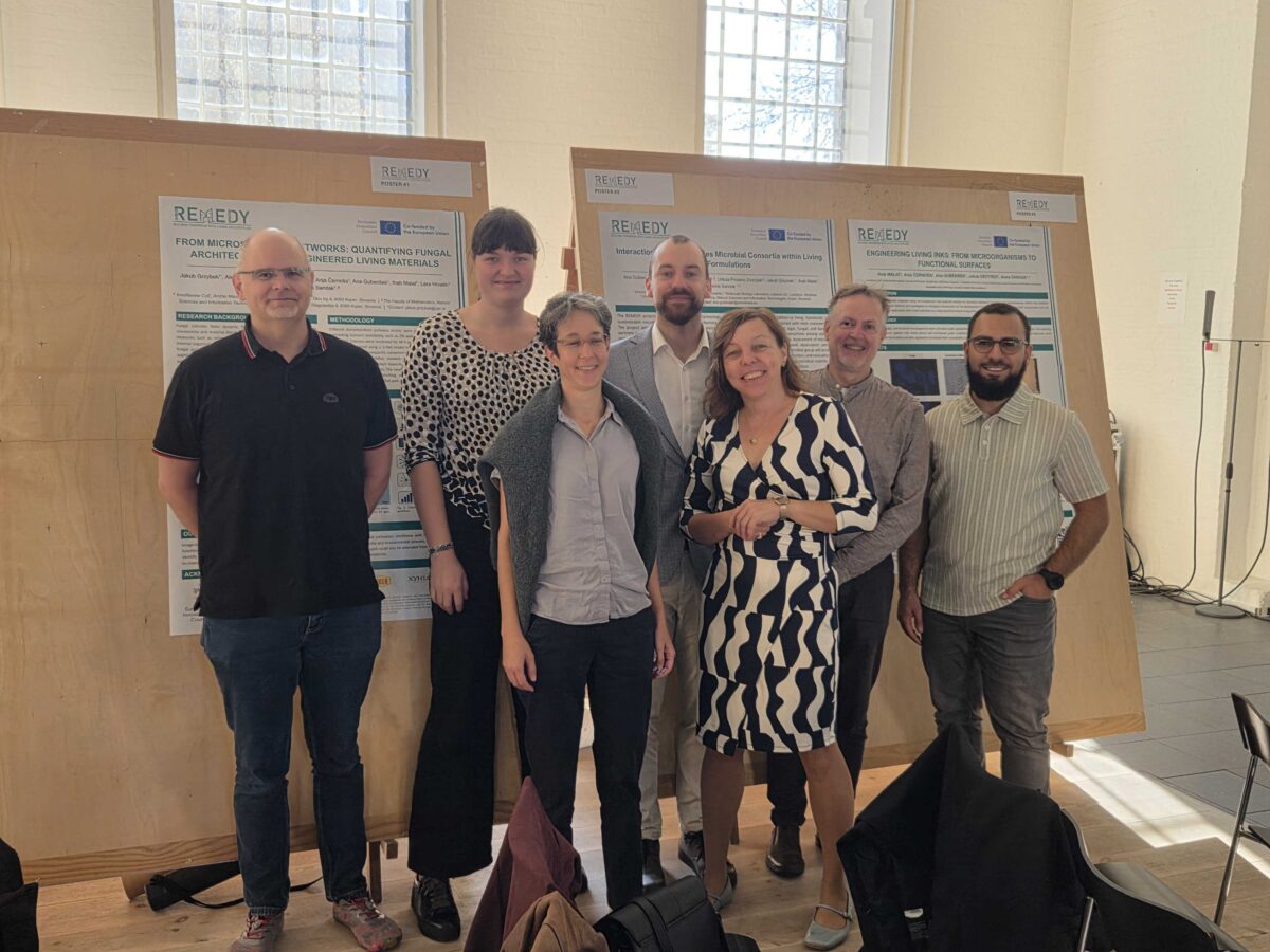 Group picture infront of posters.(Anna Sandak, Jakub Grzybek, Ihab Malat, Ana Gubenšek )